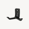Black double wall hook by STAALFABRIQ, mounted on a wall, showing its sturdy metal design for hanging items.