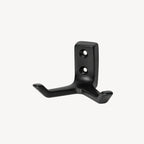 Black double wall hook by STAALFABRIQ, mounted on a wall, showing its sturdy metal design for hanging items.