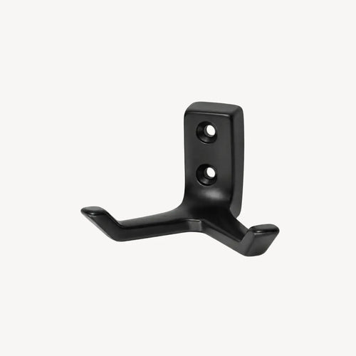 Black double wall hook by STAALFABRIQ, mounted on a wall, showing its sturdy metal design for hanging items.