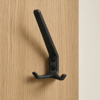 Black coat rack with three hooks from STAALFABRIQ, featuring a sleek mat finish and modern design.