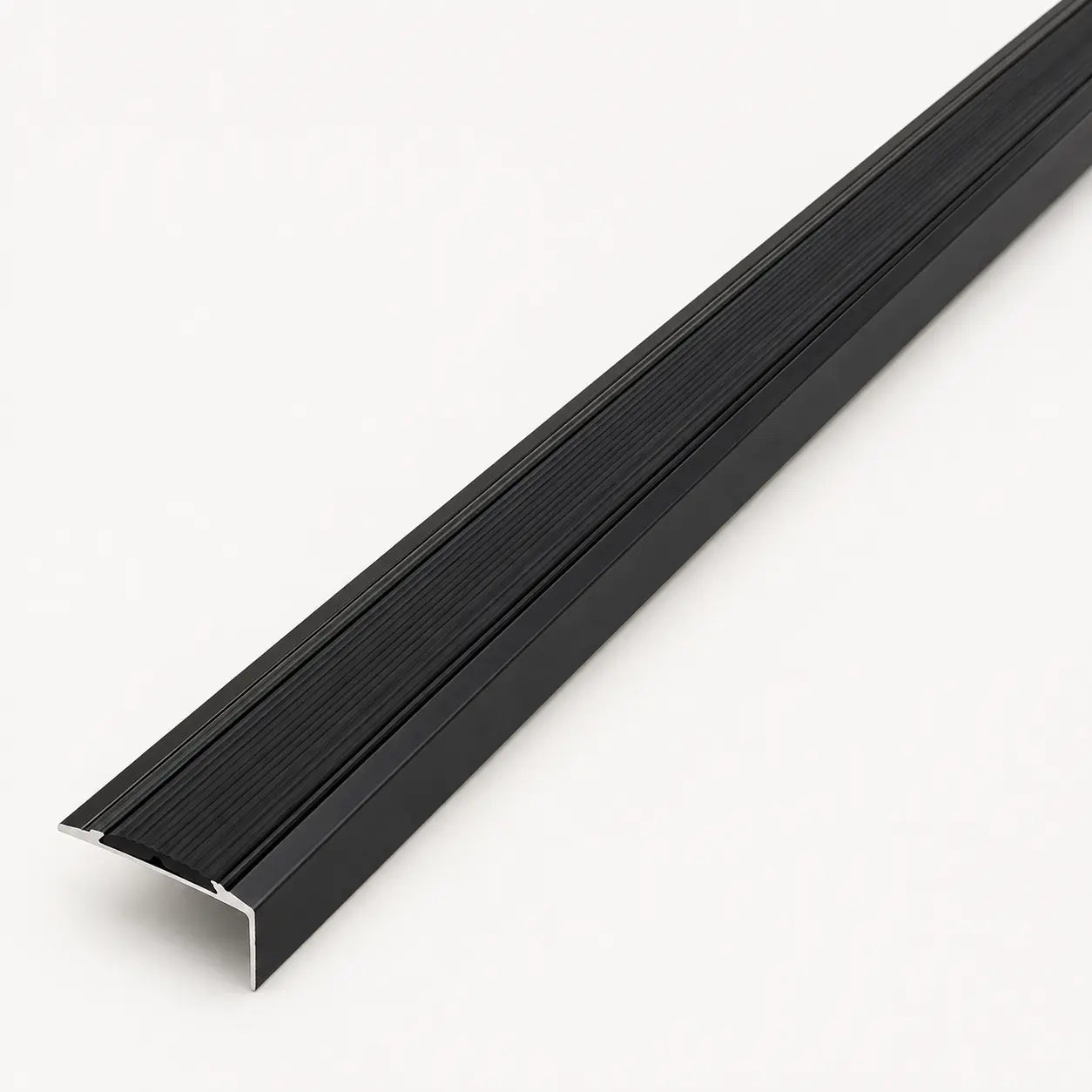 Black stair nosing profile from STAALFABRIQ, showing the textured rubber surface designed for stair edge safety.