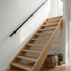 Black round seamless 30mm steel handrail trapleuning by STAALFABRIQ, showing the smooth, polished surface and rounded design.